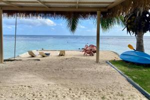 a sandy beach with a view of the ocean at Villa Maui1 in Vaihi +11 photos