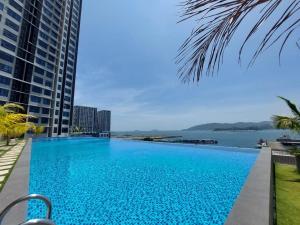 a large swimming pool with a view of the water at J'Stay Seaview Suite Jesselton Quay Kota Kinabalu in Kota Kinabalu