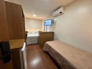 a hospital room with two beds and a tv at Casa Emma Gramado 4 in Gramado