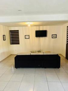 a room with two beds and a flat screen tv at la kasaloc in Saint-Laurent du Maroni +13 photos