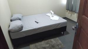 a small bed with a white bunny on top of it at Sal-beach in Salinópolis