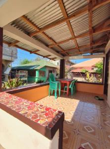an outdoor patio with a table and chairs at Patar White Beach Bolinao- LILYBETH TRANSIENT HOUSE 1 # -NOT Beachfront in Bolinao +27 photos