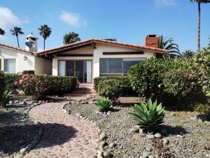 a house with a walkway in front of it at Hotel Quintas Papagayo in Ensenada