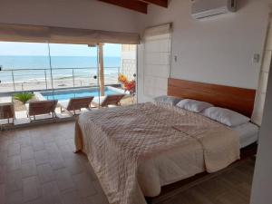 a bedroom with a bed and a swimming pool at La Casa de David in Zorritos +35 photos