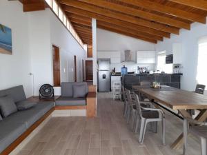 a large living room with a table and a kitchen at La Casa de David in Zorritos