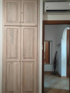 a pair of wooden cabinets in a room at La rosa dei venti in Santa Teresa Gallura +7 photos