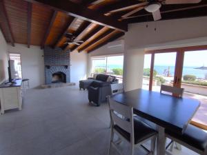 a living room with a table and a fireplace at Hotel Quintas Papagayo in Ensenada