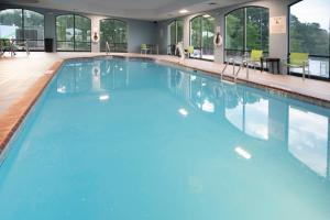 a large swimming pool with blue water at Holiday Inn Express Suites Little Rock West by IHG in Little Rock