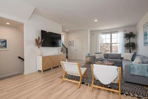 a living room with a couch and a table at New Intown Waterfront Townhome wPool & Location in Cambridge