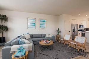 a living room with a couch and a table at New Intown Waterfront Townhome wPool & Location in Cambridge