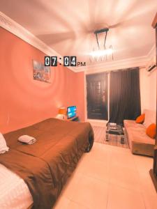 a bedroom with a bed and a couch in it at Layback apartment in 6 October city Cairo in 6th Of October