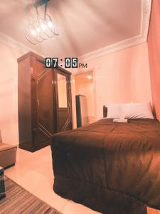 a bedroom with a bed and a large mirror at Layback apartment in 6 October city Cairo in 6th Of October