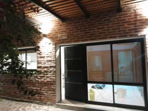 a glass door on a brick building at La tranquera in La Paz