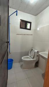 a bathroom with a toilet and a sink at Patar White Beach Bolinao- LILYBETH TRANSIENT HOUSE 1 # -NOT Beachfront in Bolinao
