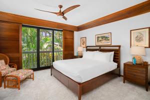 a bedroom with a bed and a large window at 1br Ocean View Condo at Poipu Kapili in Koloa