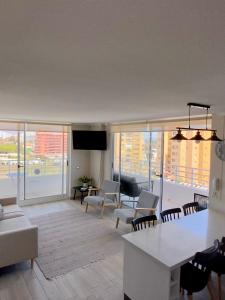 a living room with a couch and a table at Depto en La Serena con vista al mar in La Serena