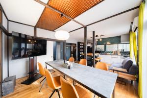 a dining room and living room with a table and chairs at 【海と城ヶ島大橋まで3分の貸切一軒家】ブルーピリオドMIURA in Moroiso