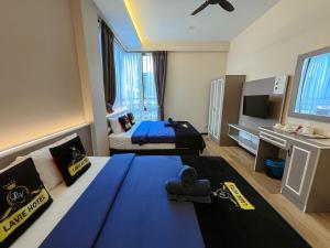 Postel nebo postele na pokoji v ubytování Hotel Lavie at Centrum