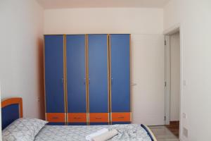 a bedroom with a blue and orange cabinet at Holiday Gateway in Shëngjin