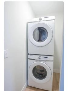 a washer and a washing machine in a room at Modern Suite OTR PAYCOR STADIUM in Cincinnati