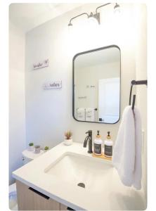 a bathroom with a sink and a mirror at Modern Suite OTR PAYCOR STADIUM in Cincinnati