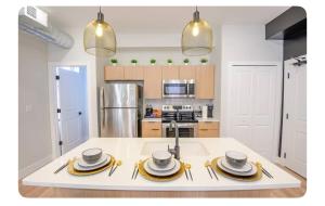 a kitchen with a table with plates and bowls on it at Modern Suite OTR PAYCOR STADIUM in Cincinnati