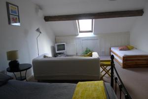 a room with two beds and a couch and a television at Totters Hostel in Caernarfon