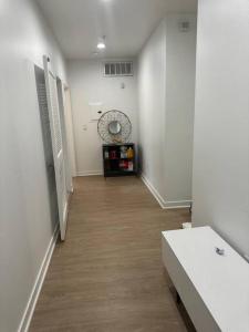 einen Flur mit weißen Wänden und Holzböden in der Unterkunft The Carlton - Modern-Lux 2 Master Suites-Secure Bldg & Parking- 5 BLKS to Ocean Ave in Los Angeles