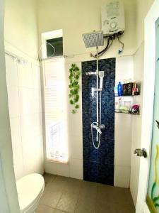 a shower in a bathroom with a toilet at Villa Plumeria A3 in Jember +22 photos