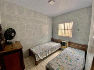 En eller flere senge i et værelse på Casa em Itamaracá