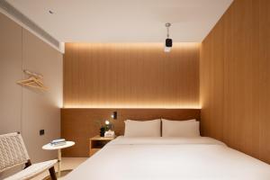 Shanghai Captain 5 Youth Hotel - Xinzhuang Metro Station 객실 침대
