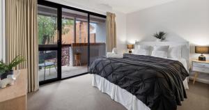 a bedroom with a large bed and a balcony at Forest Edge Villa - Family Friendly - Walk To Town in Margaret River Town +16 photos