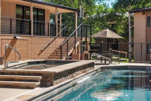 a swimming pool in front of a house at Woodbridge 27E in Snowmass Village