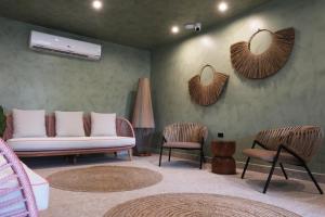 a living room with a couch and two chairs and mirrors at Bali Hotel Adults Only Isla Verde, a Trademark by Wyndham in San Juan +106 photos
