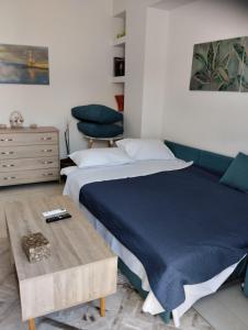 a bedroom with a bed and a table and a chair at Ethereum City Αpartment - Suite in Chania