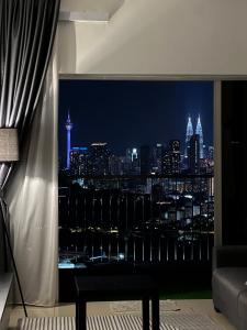 a room with a view of a city at night at Razak City Residence by Lisa Homestay in Kuala Lumpur