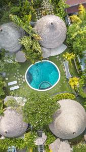 an aerial view of a swimming pool in a garden at Oasis Bungalows in Uluwatu