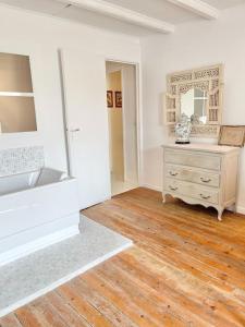 a white room with a dresser and a mirror at Maison bucolique champs de blé in Villers-Agron-Aiguizy +28 photos