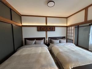 Postel nebo postele na pokoji v ubytování 鴨川ビーチサイドヴィラ + 34 fotografií