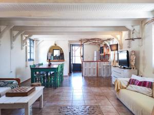 a living room with a couch and a table at Nectar Cottages in Varákkes