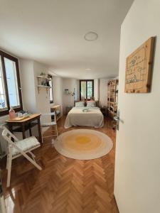 a bedroom with a bed and a table and a desk at Glasbeni atelje Tri ptičice in Kranj +15 photos