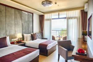 Kama o mga kama sa kuwarto sa Jie Jie Beach Hotel