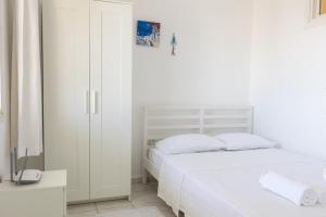 a white bedroom with a bed and a closet at Seaview Apart Bodrum in Bodrum City