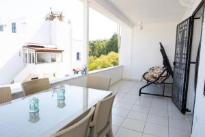 a dining room with a table and chairs and a window at Seaview Apart Bodrum in Bodrum City +17 photos