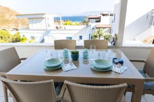 a table with plates and glasses on a balcony at Seaview Apart Bodrum in Bodrum City