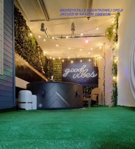 a corporate event with a cocacola sign and a green floor at BORÓWNO WIELKIE Skarszewy Domek letniskowy - apartamenty letniskowe in Skarszewy