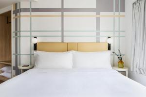 A bed or beds in a room at Ying'nFlo, Wesley Admiralty, Hong Kong