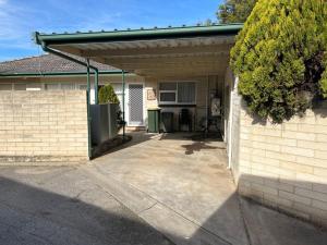 a garage with awning on the side of a house at Comfortable Unit Close to the Beach in Victor Harbor