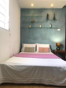a bedroom with a large white bed with two pillows at Olinda Home in Olinda