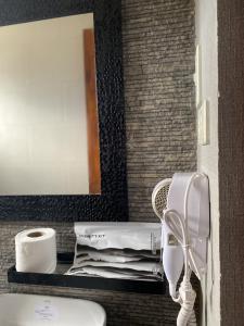 a bathroom with a sink and a mirror and a toilet at IAO Boutique Hotel in Dapa +17 photos